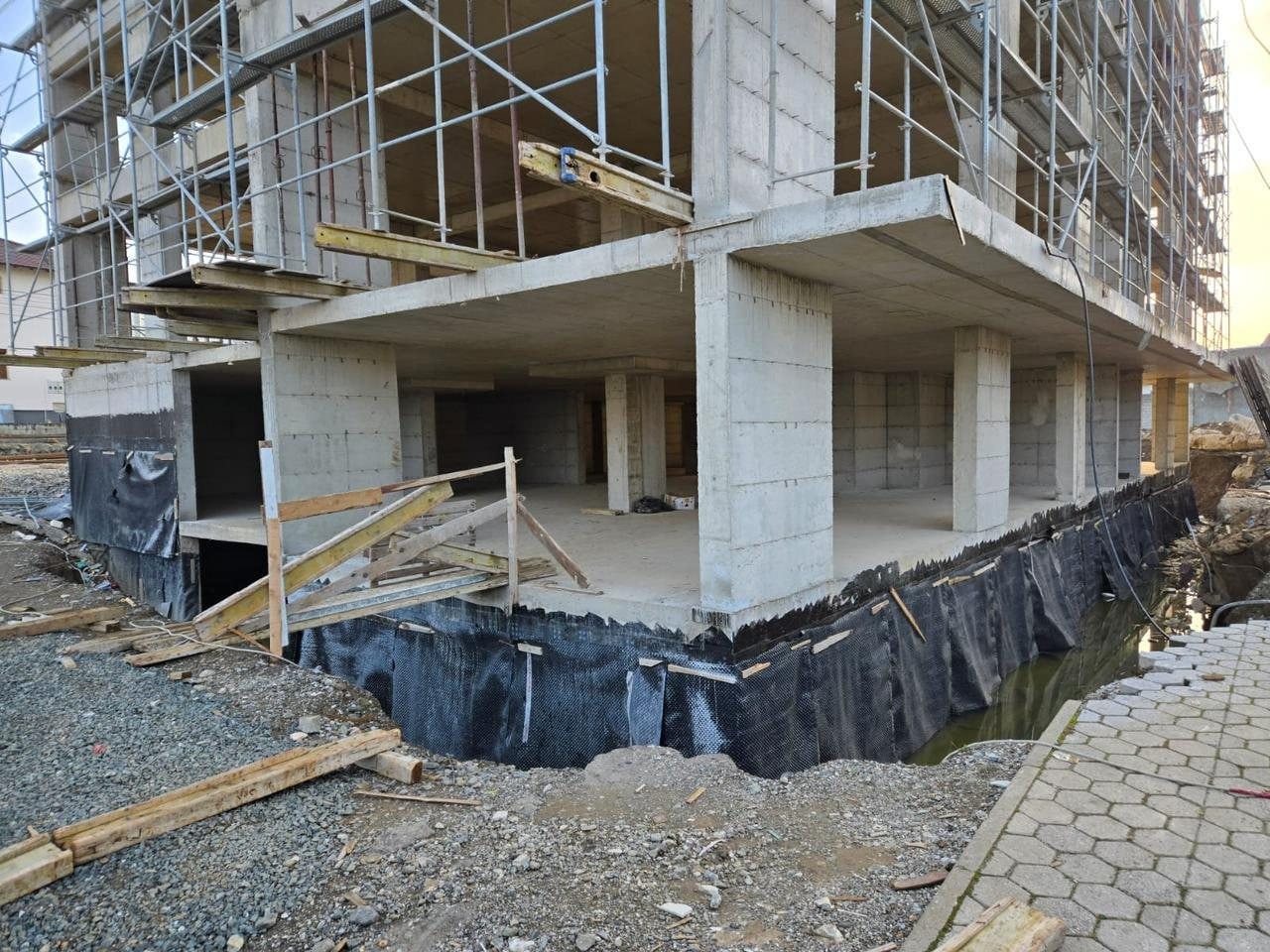 Elysium Series 1 on site: the ground-floor slab and columns with waterproofing to the basement walls.