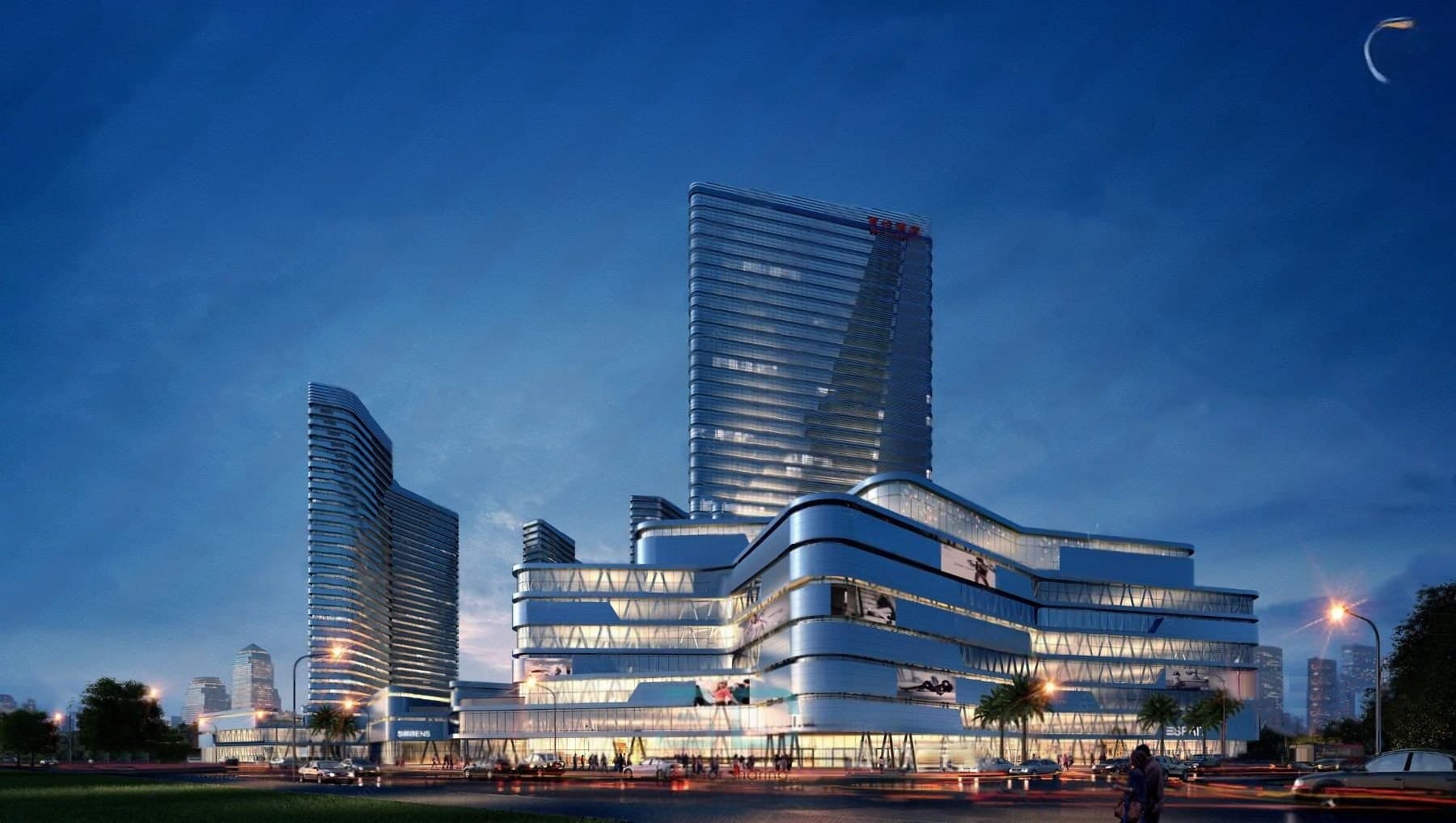 Lumen Arcadia at night: a curving mixed-use podium with banded glazing beneath a tall glass tower.