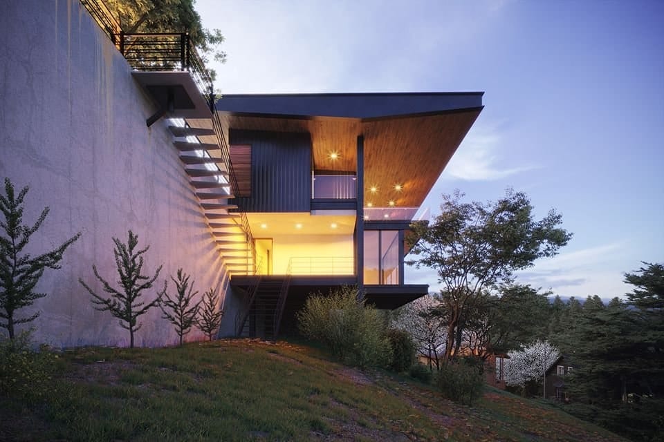 Luminaria Ridge House at dusk: a cantilevered timber-soffited upper floor over a glazed living level, set into a hillside.